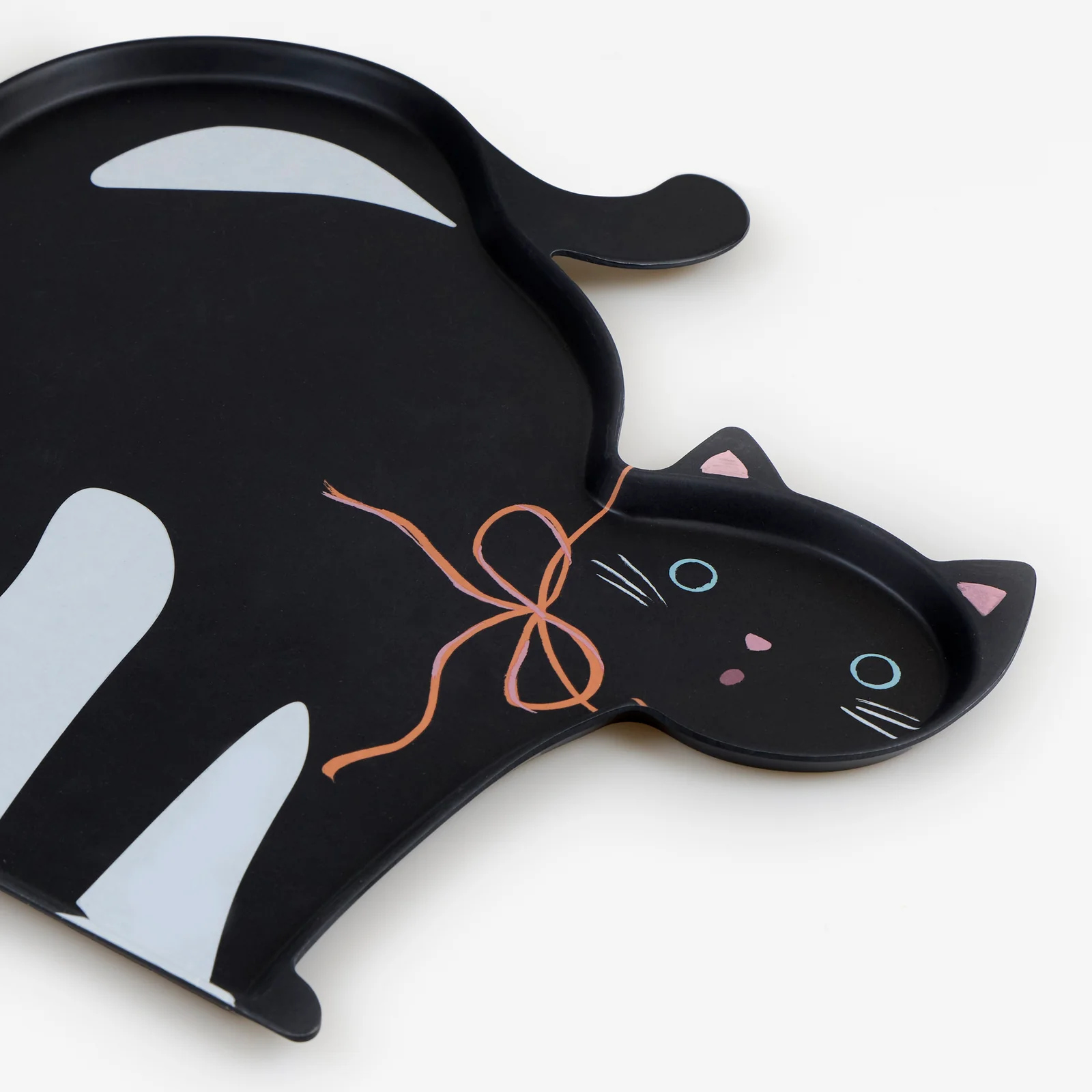 Black cat-shaped Meri Meri Halloween reusable platter with an orange bow